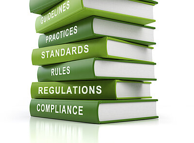 stack of books on regulations and standards