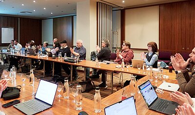 tekom Europe delegates sitting in a conference room applauding