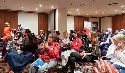 event attendees sitting and applauding a raffle winner
