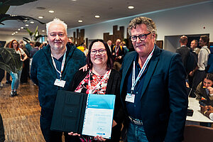 Award winner Laura Katajisto holding the certificate with Boo Engstrand and Steen Magnussen standing next to her