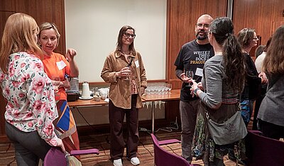 event attendees standing and talking to each other