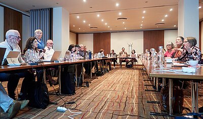 tekom Europe Assembly in a conference room with all attendees sitting in a u-shaped tables 