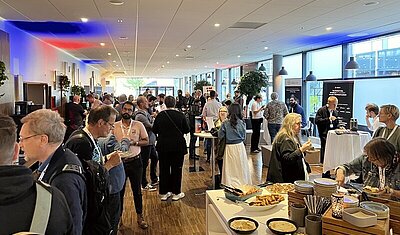 NORDIC TEchKomm Copenhagen 2025 - conference attendees are networking at the buffet