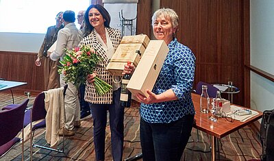Tiziana Sicilia and Magali Baumgartner holding their presents as outgoing executive board members