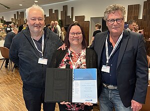 Award winner Laura Katajisto holding the certificate with Boo Engstrand and Steen Magnussen standing next to her