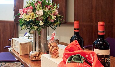 flower bouquet and wine bottles as presents to the outgoing executive board