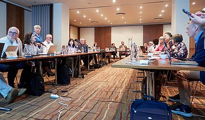 tekom Europe Assembly in a conference room with all attendees sitting in a u-shaped tables