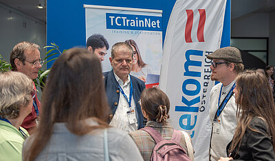 tekom Österreich board members talking with people at the tekom Europe stand